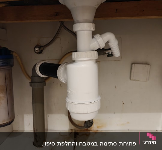 צנרת מתחת לכיור עם סימני חלודה